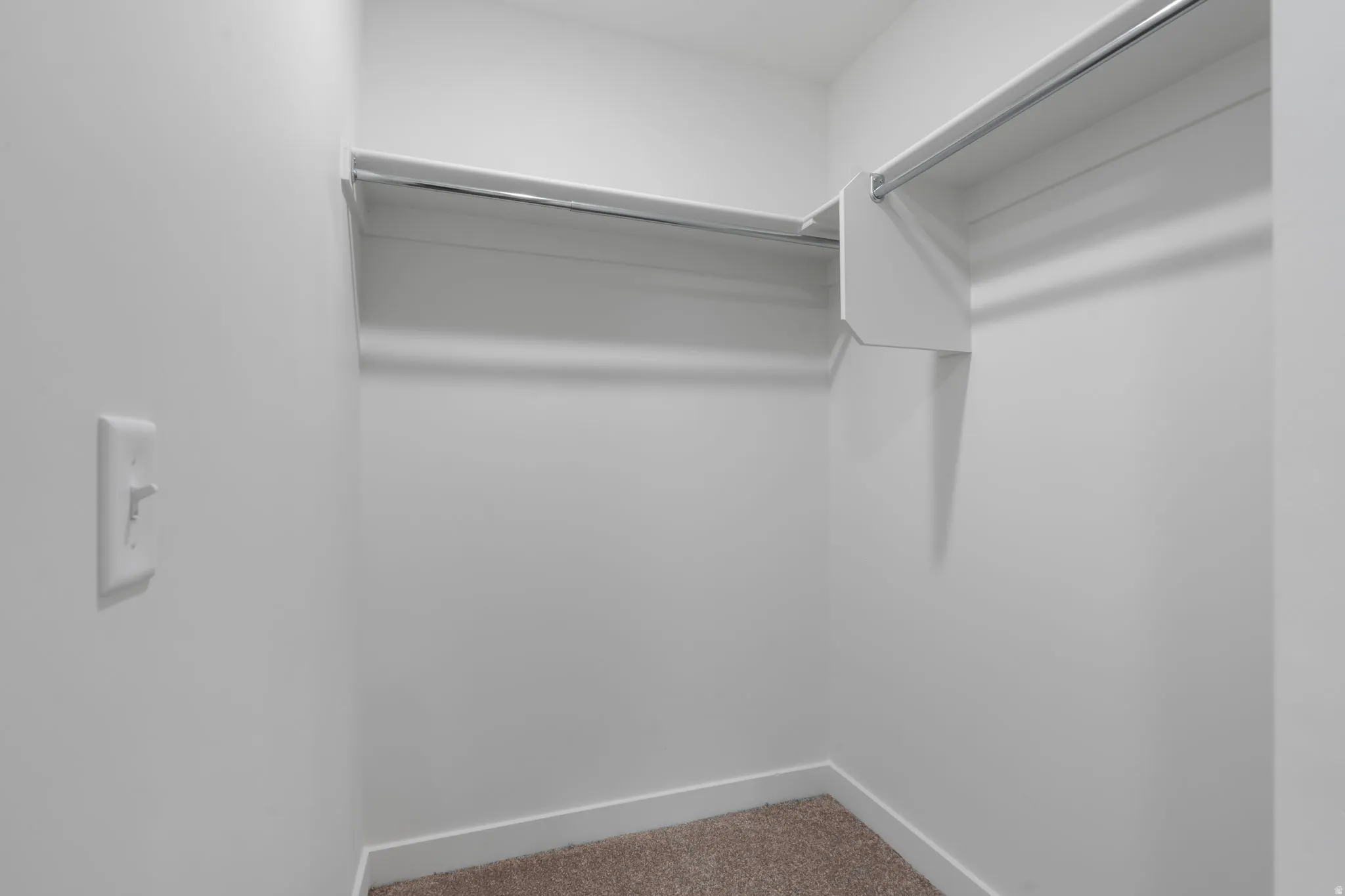 Walk in closet with carpet flooring