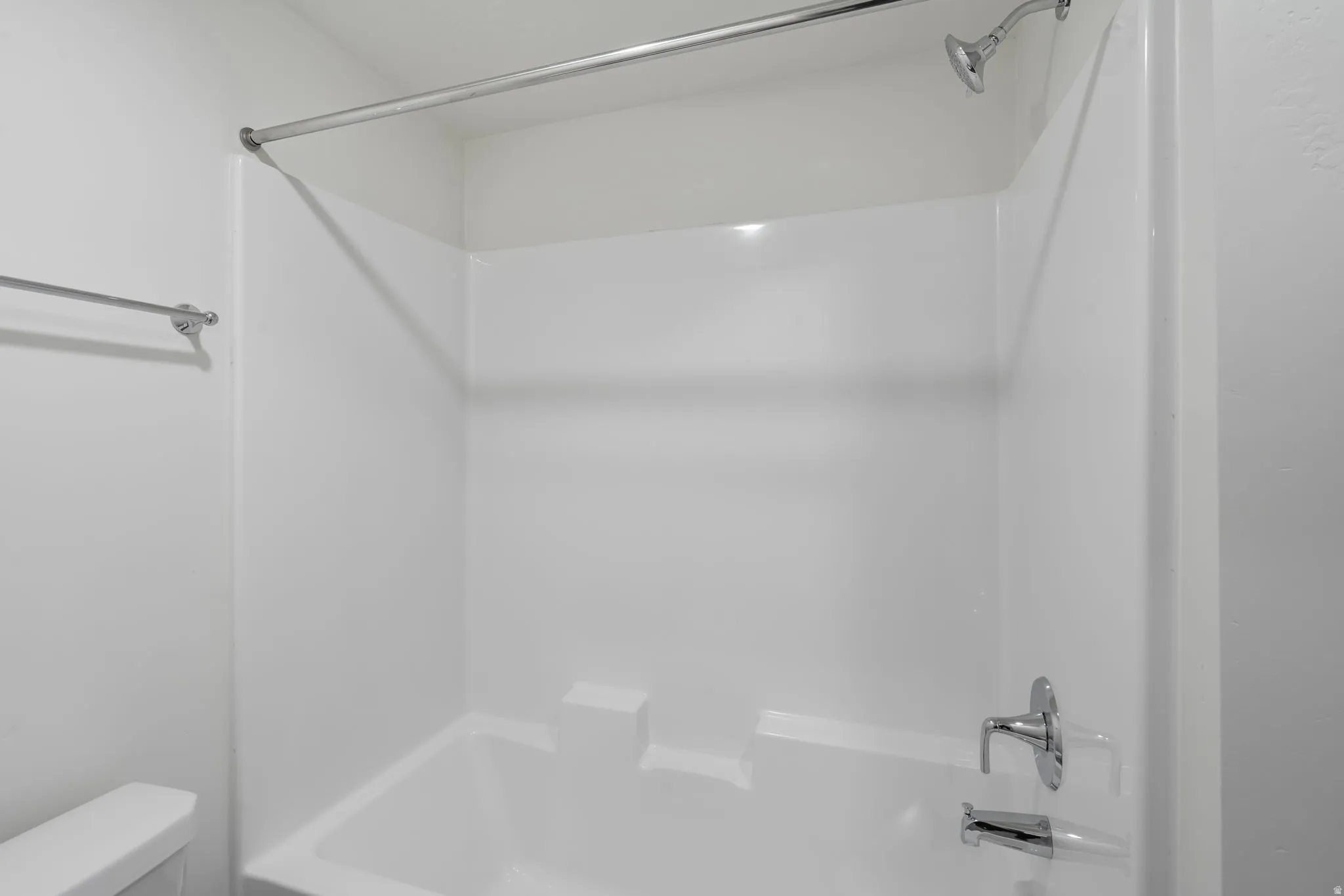 Bathroom with shower / washtub combination and toilet