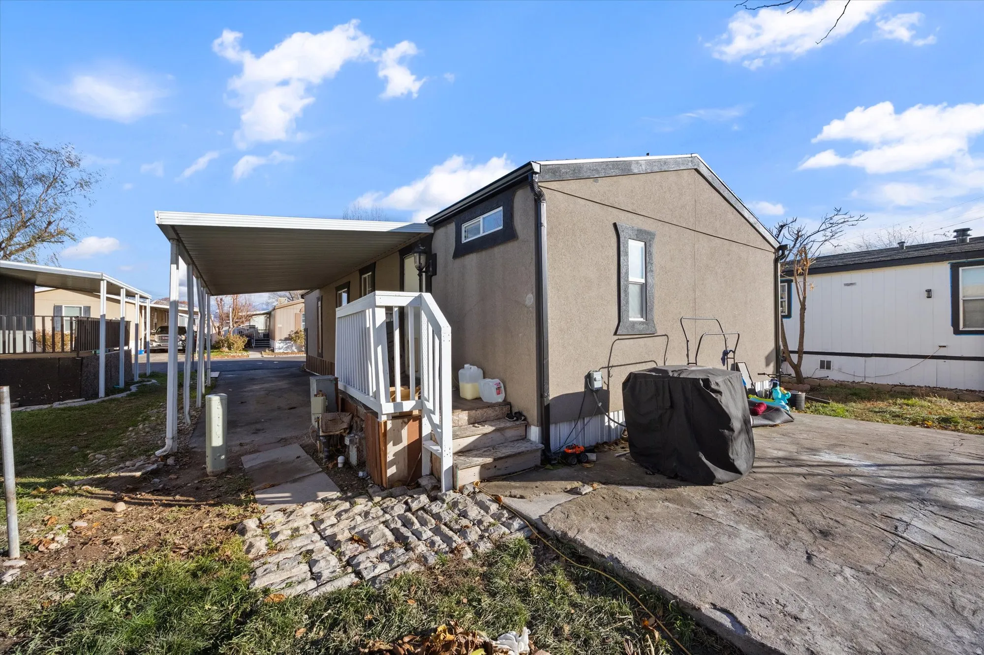 View of home's exterior featuring stucco siding and a carport