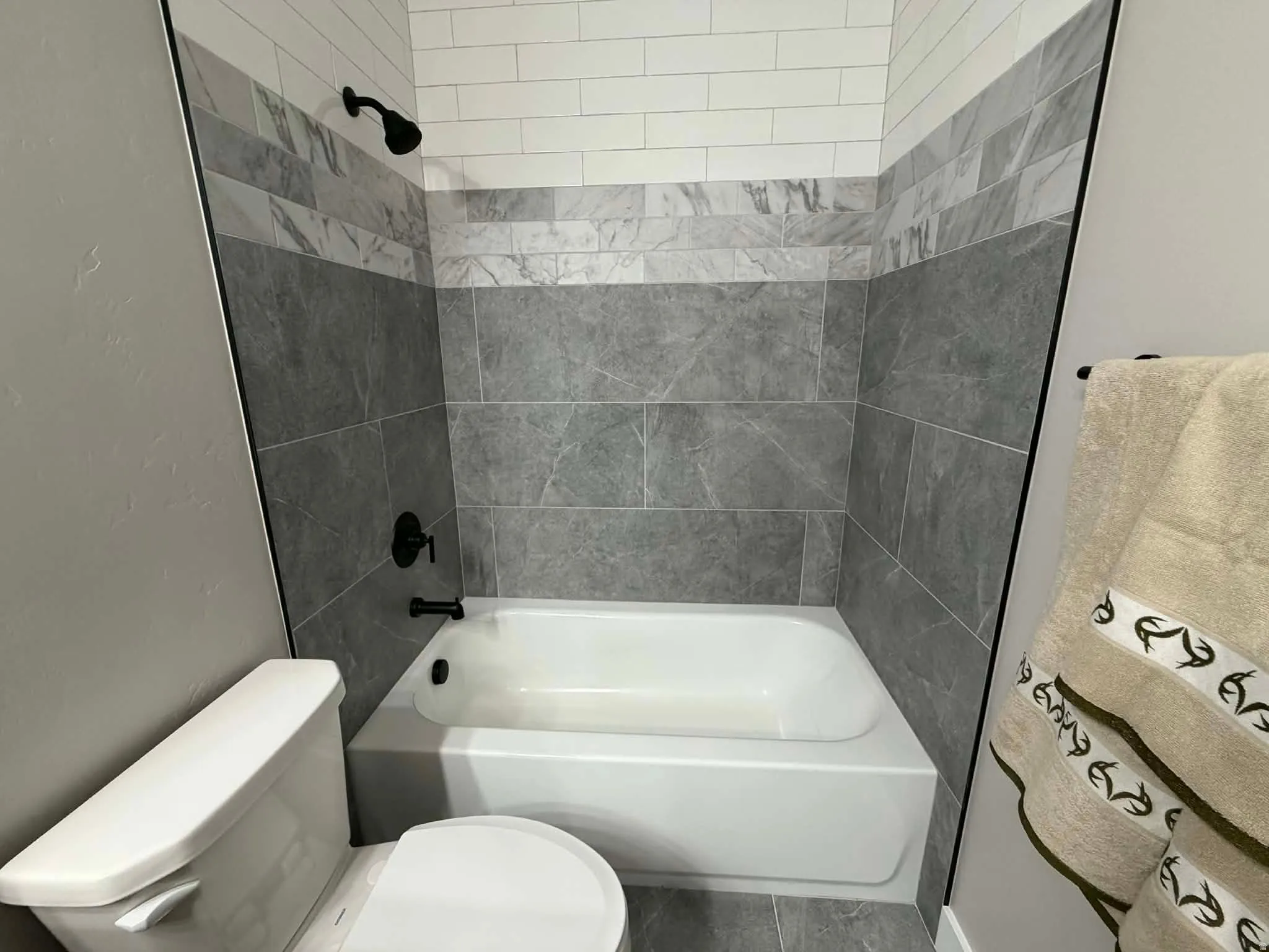 Bathroom with shower / bath combination and toilet