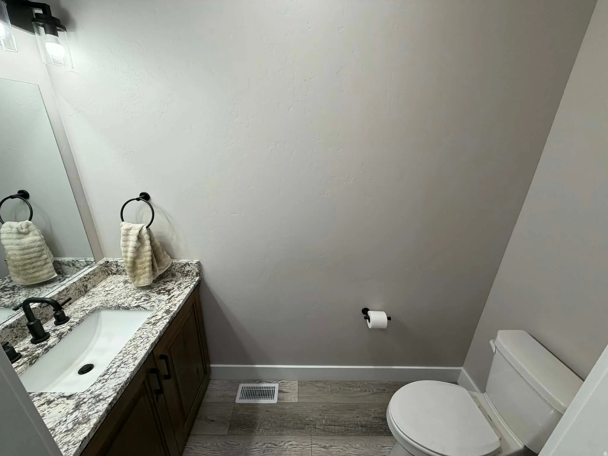 Bathroom featuring vanity and light wood-style floors