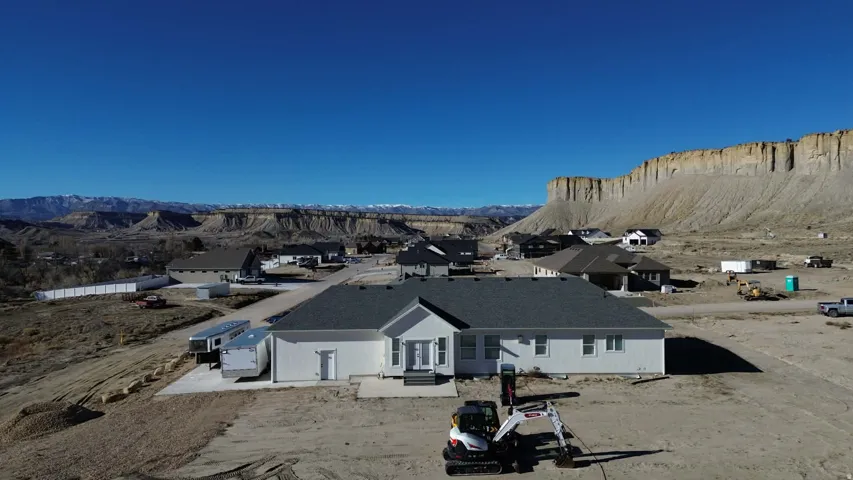 Rear view of property with a mountain view and a residential view