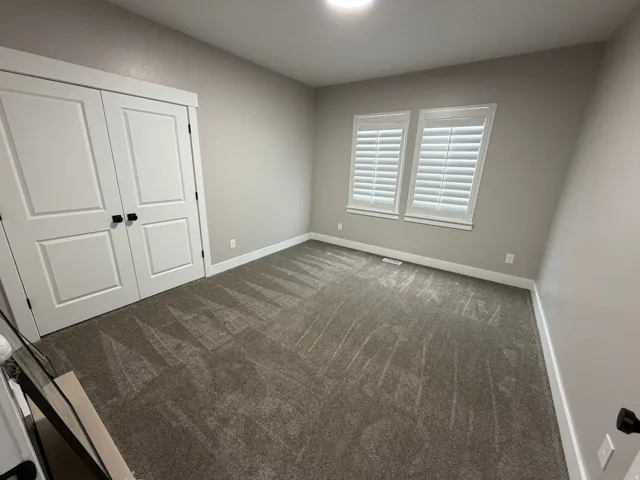 Unfurnished bedroom with a closet and carpet