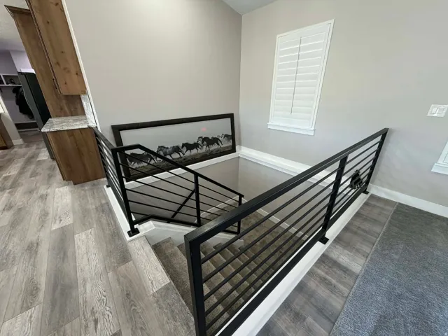 Stairs with wood finished floors and baseboards