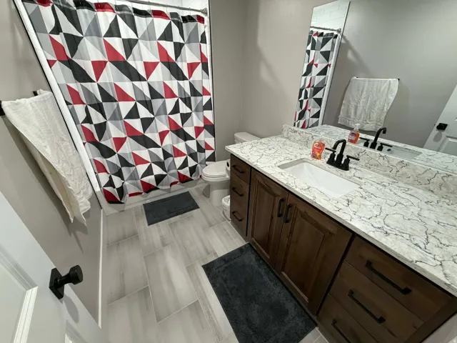 Bathroom with curtained shower and vanity