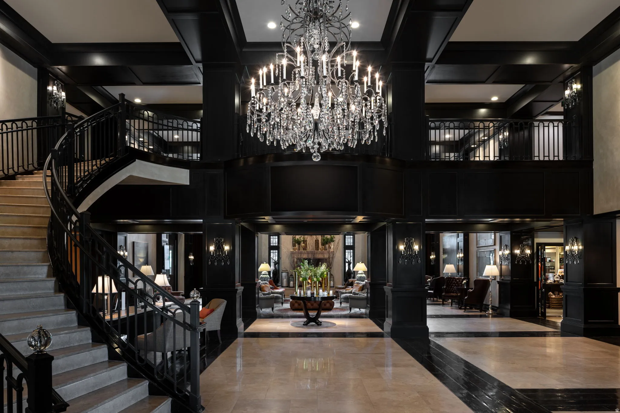Community lobby with stairs, a towering ceiling, and a decorative wall