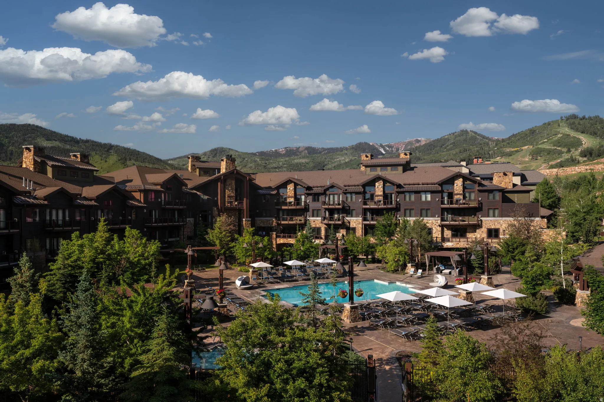 Community pool featuring a mountain view, a patio area, and a residential view