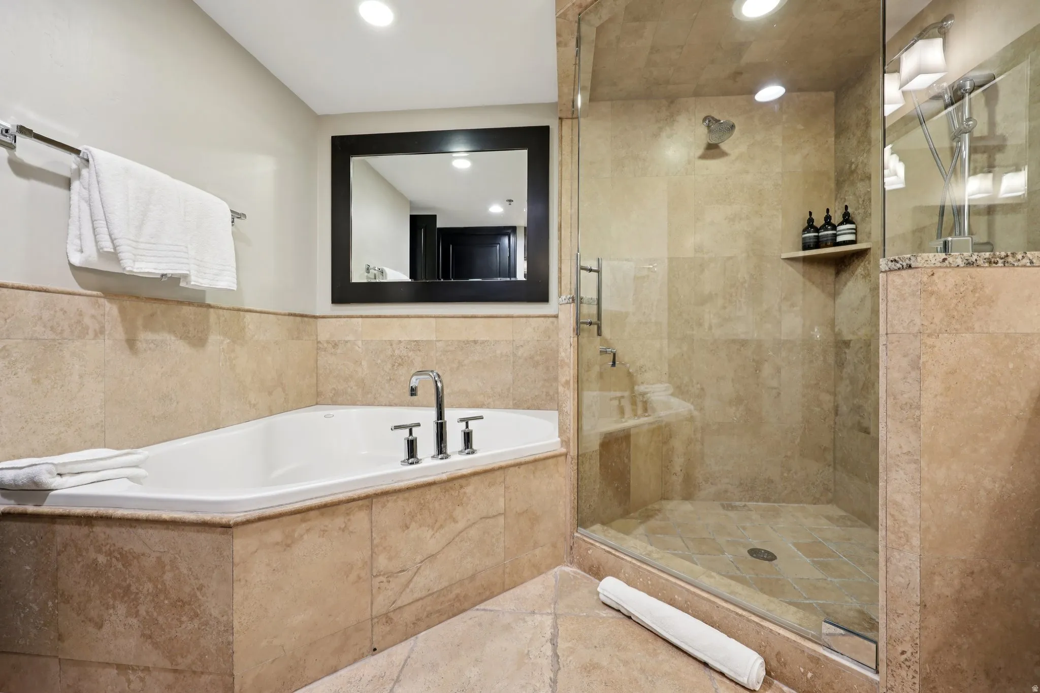 Full bathroom featuring a garden tub, a shower stall, and recessed lighting