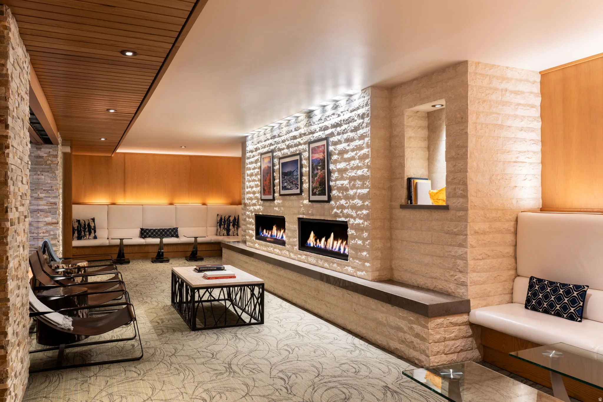 Living area featuring a lit fireplace, wood ceiling, and recessed lighting