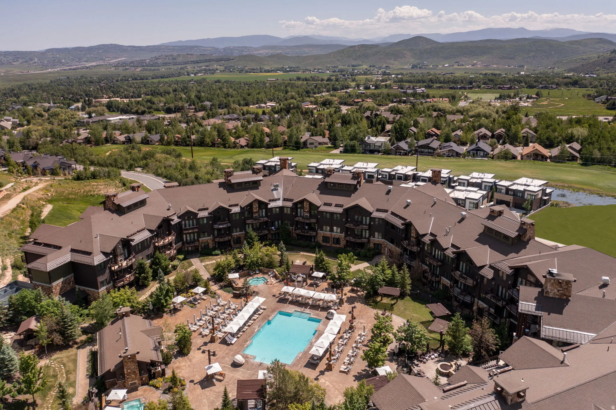 Aerial view of a mountain backdrop and a pool