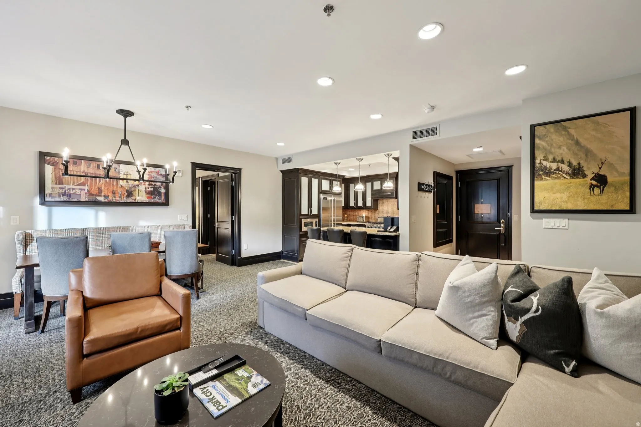 Living room with recessed lighting, a chandelier, and carpet floors