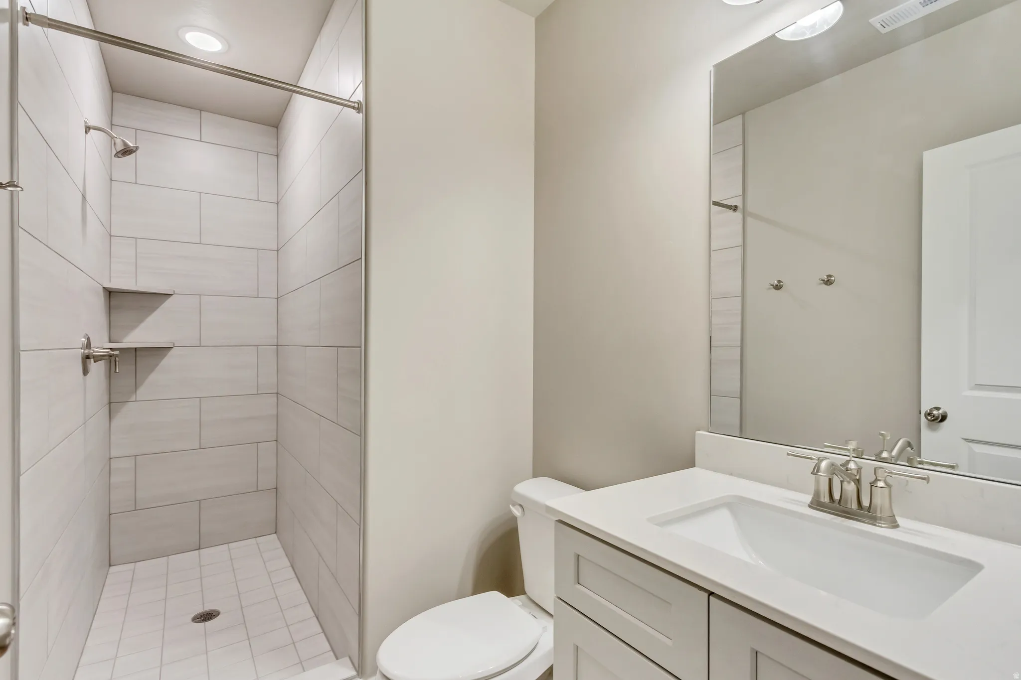 Full bathroom with vanity and a stall shower