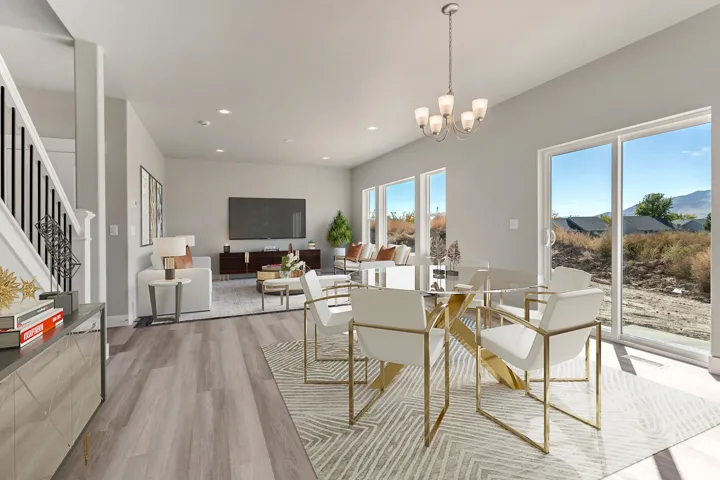 Open-concept living space with wood-finish flooring, a contemporary chandelier, multiple windows, and a sliding glass door