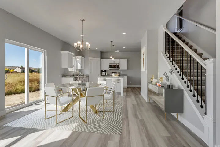 Spacious open-concept living area with wood-finish flooring