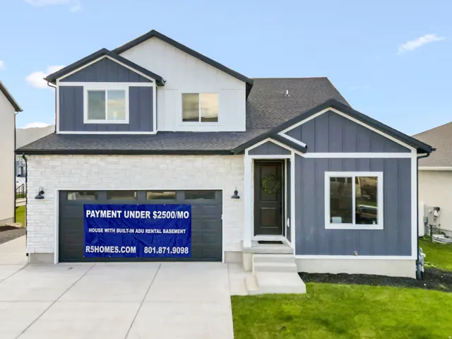 View of front of house with a front lawn, board and batten siding, a garage, concrete driveway, and a shingled roof