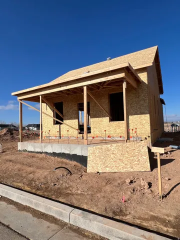 View of side of property with roof with shingles