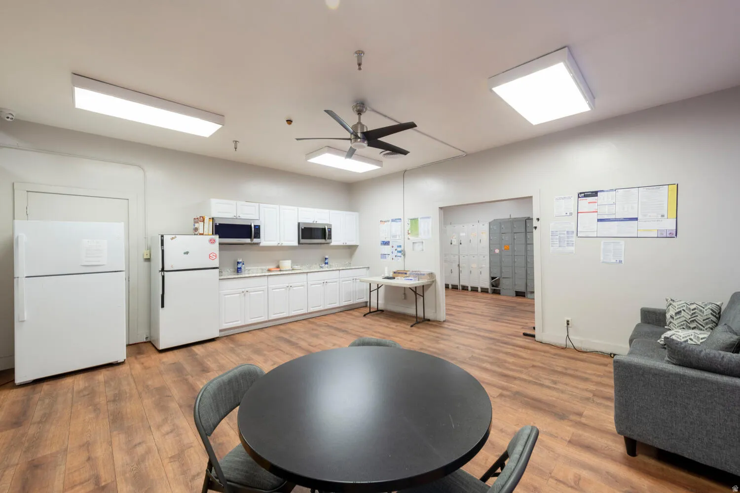Living room featuring ceiling fan and light wood finished floors