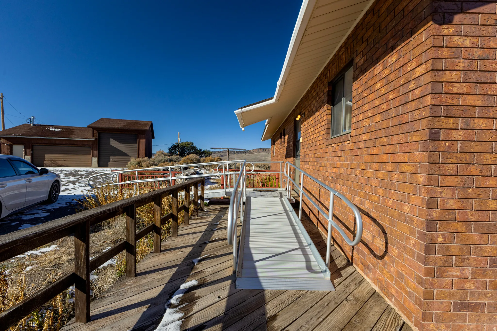 View of home's exterior with brick siding and a deck