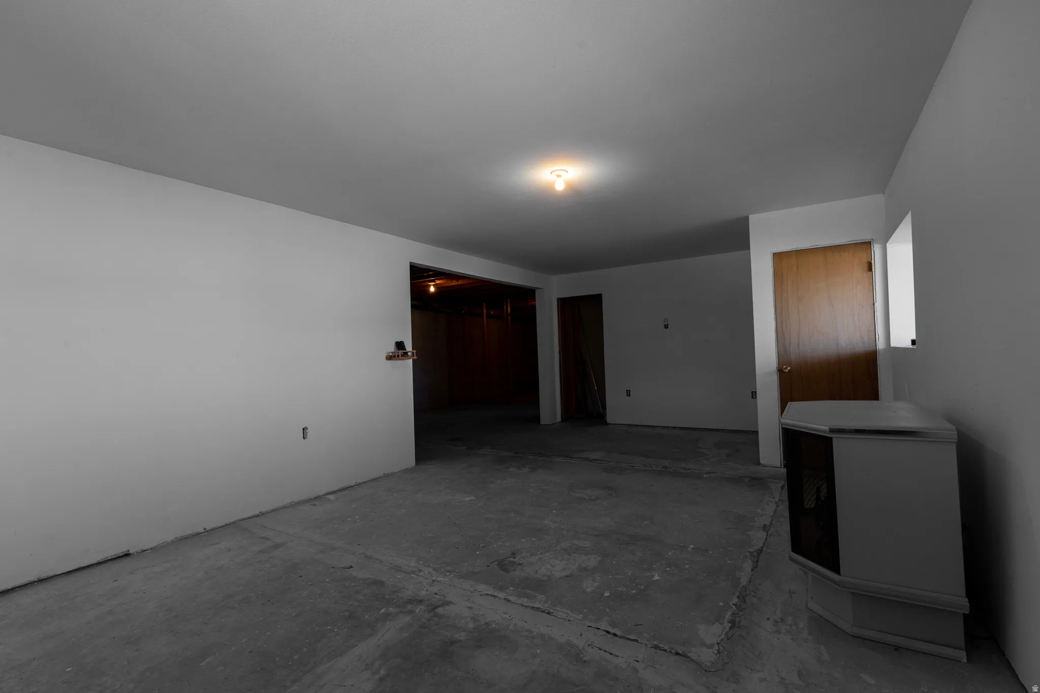 Unfurnished room with unfinished concrete floors