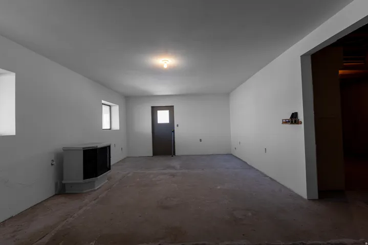 Entrance foyer featuring unfinished concrete floors