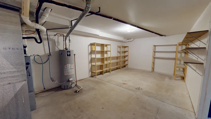 Garage featuring heating unit and water heater