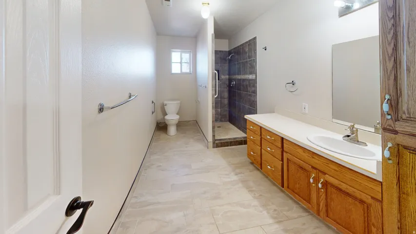 Bathroom featuring vanity and a shower stall