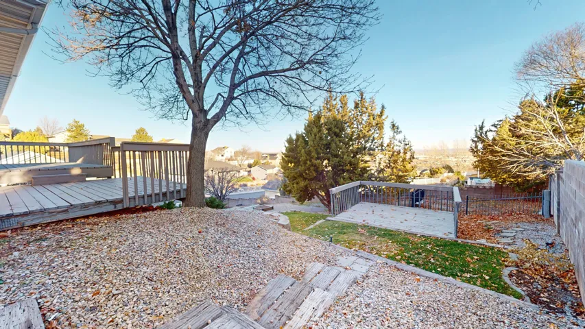 Fenced backyard with a wooden deck