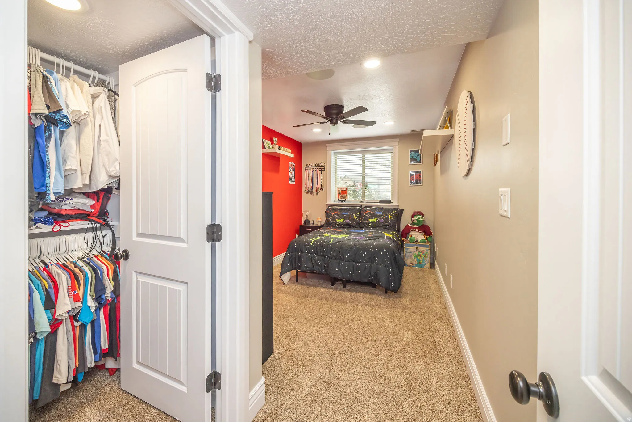 Bedroom with light colored carpet, recessed lighting, a textured ceiling, and a closet