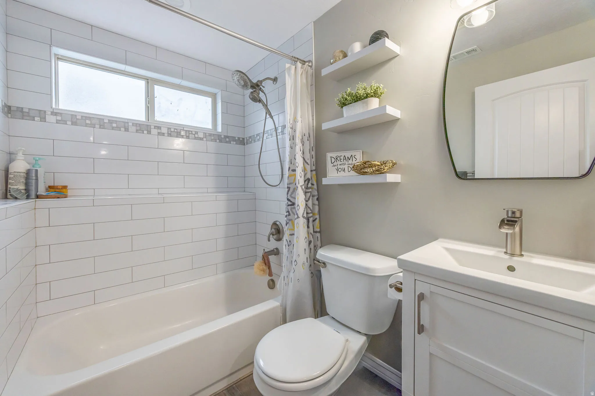 Full bath featuring vanity and shower / bathtub combination with curtain
