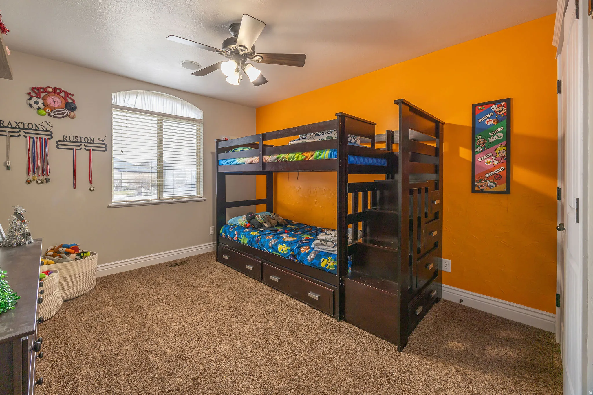 Carpeted bedroom with baseboards and ceiling fan