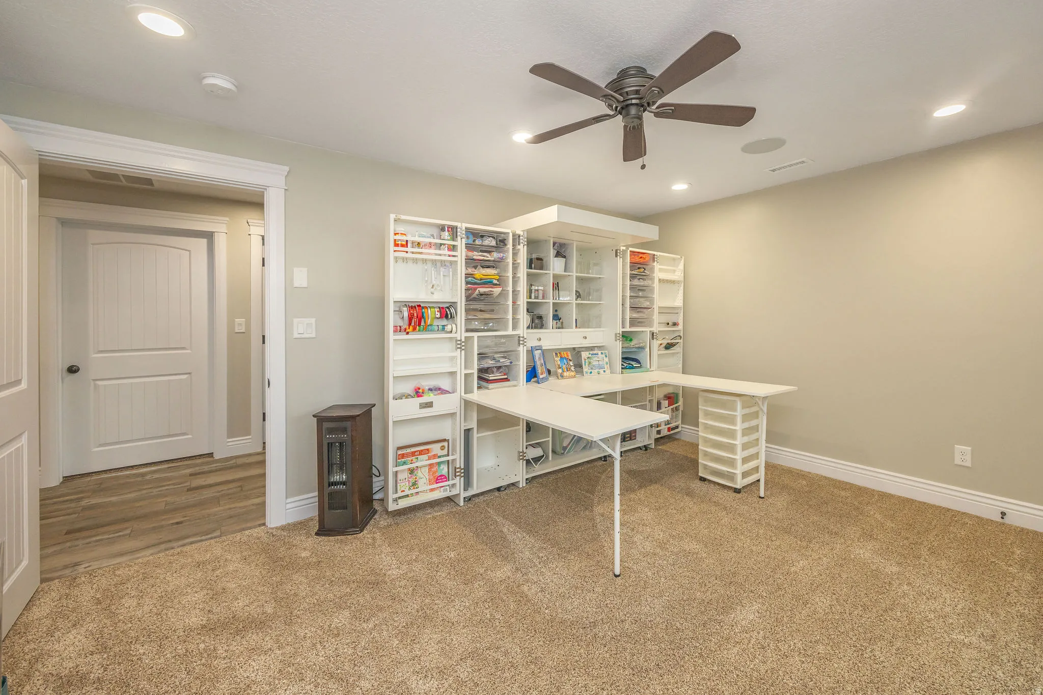 Home office with light colored carpet, a ceiling fan, and recessed lighting