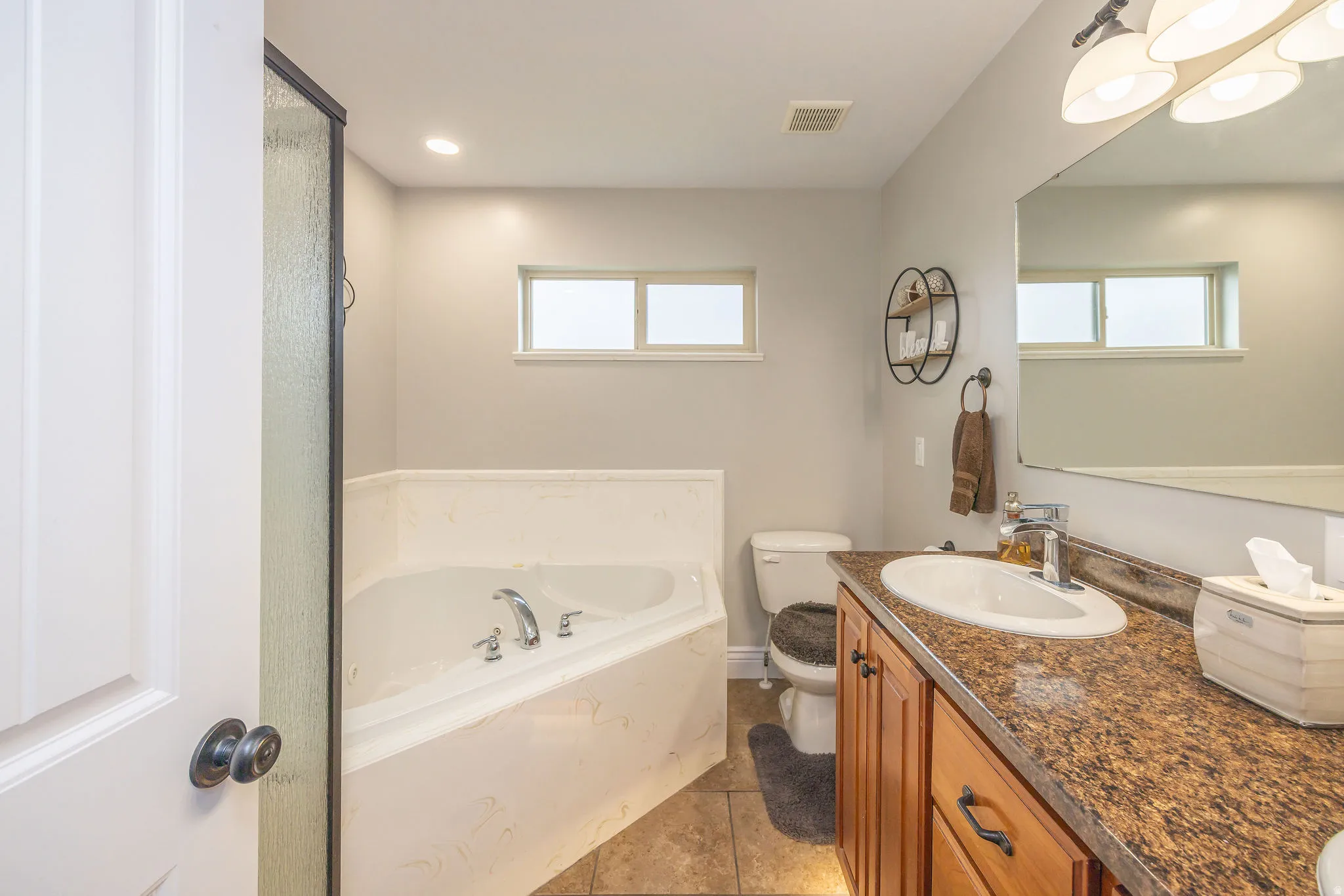 Full bath featuring vanity, a bath, light tile patterned floors, and recessed lighting