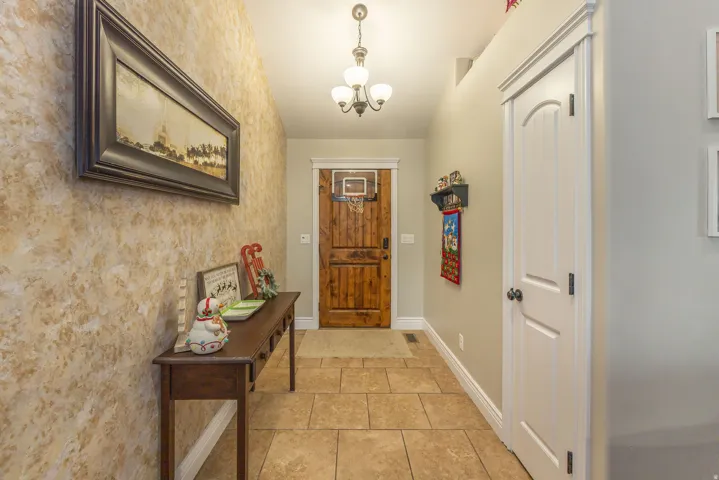 Entryway with a chandelier and tile patterned floors
