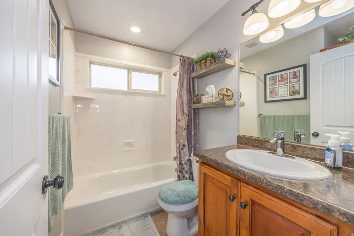 Full bathroom featuring vanity and shower / bath combination with curtain
