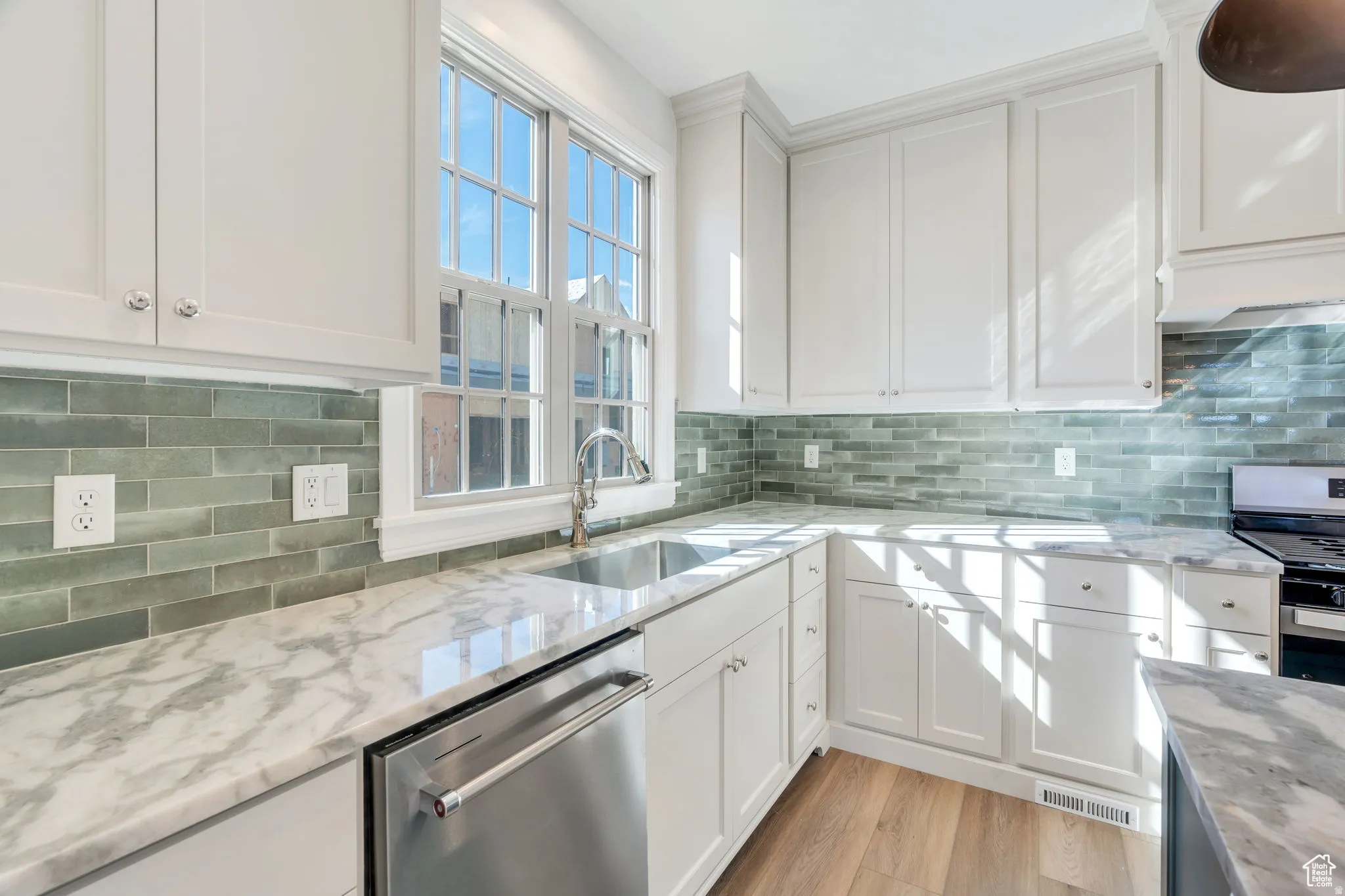 Granite countertops  complement the backsplash