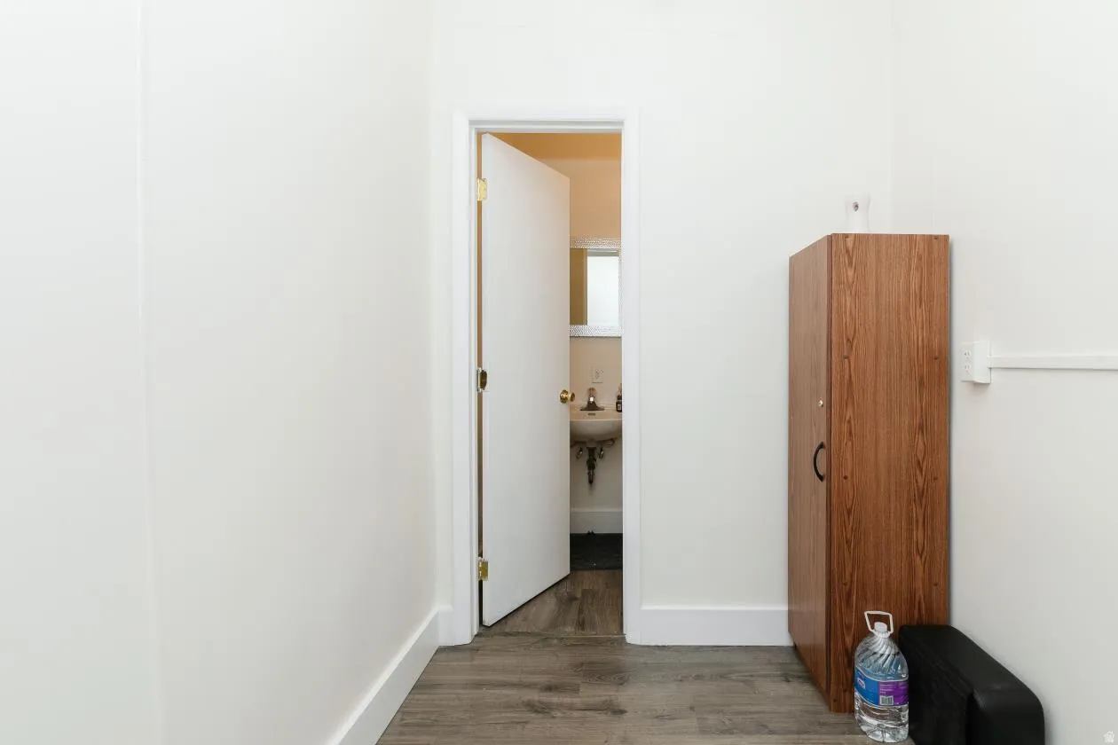 Hallway leading to bathroom connected to hair salon