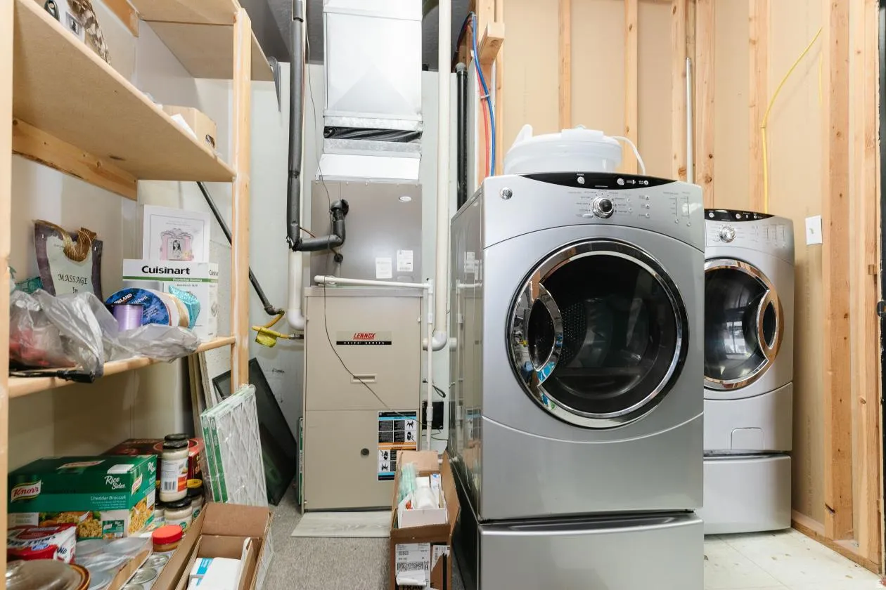 Washroom featuring heating unit and washer and clothes dryer