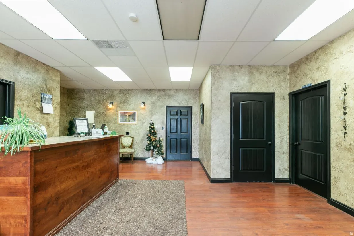 Welcome area with a drop ceiling and wallpapered walls