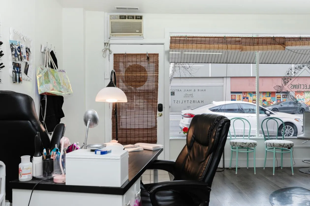 Office space with wood finished floors and a wall unit AC