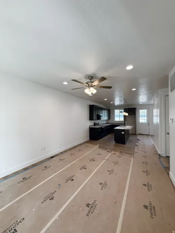 Unfurnished living room with a ceiling fan and recessed lighting