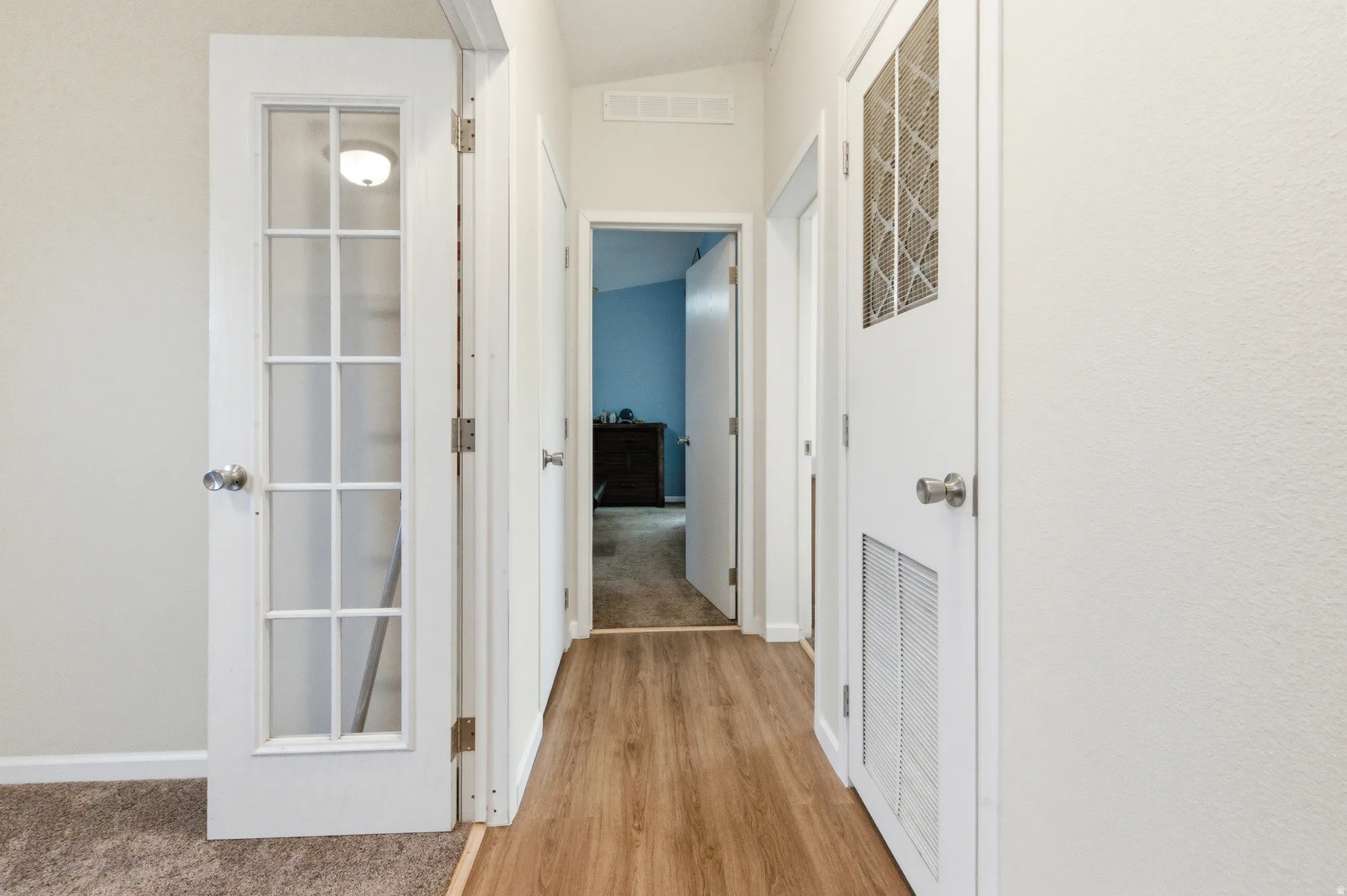 Corridor featuring light carpet