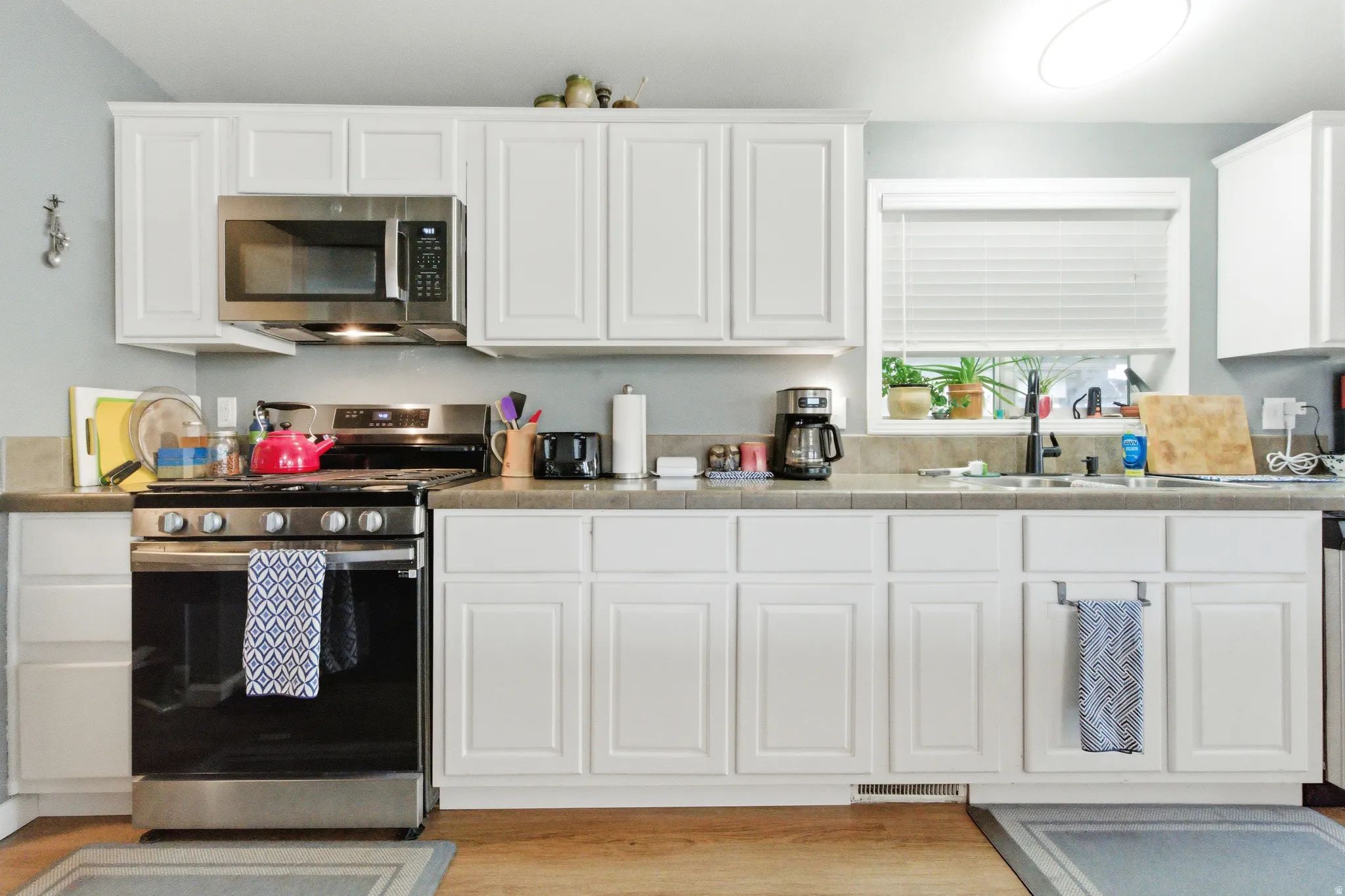 Kitchen with appliances with stainless steel finishes and white cabinets