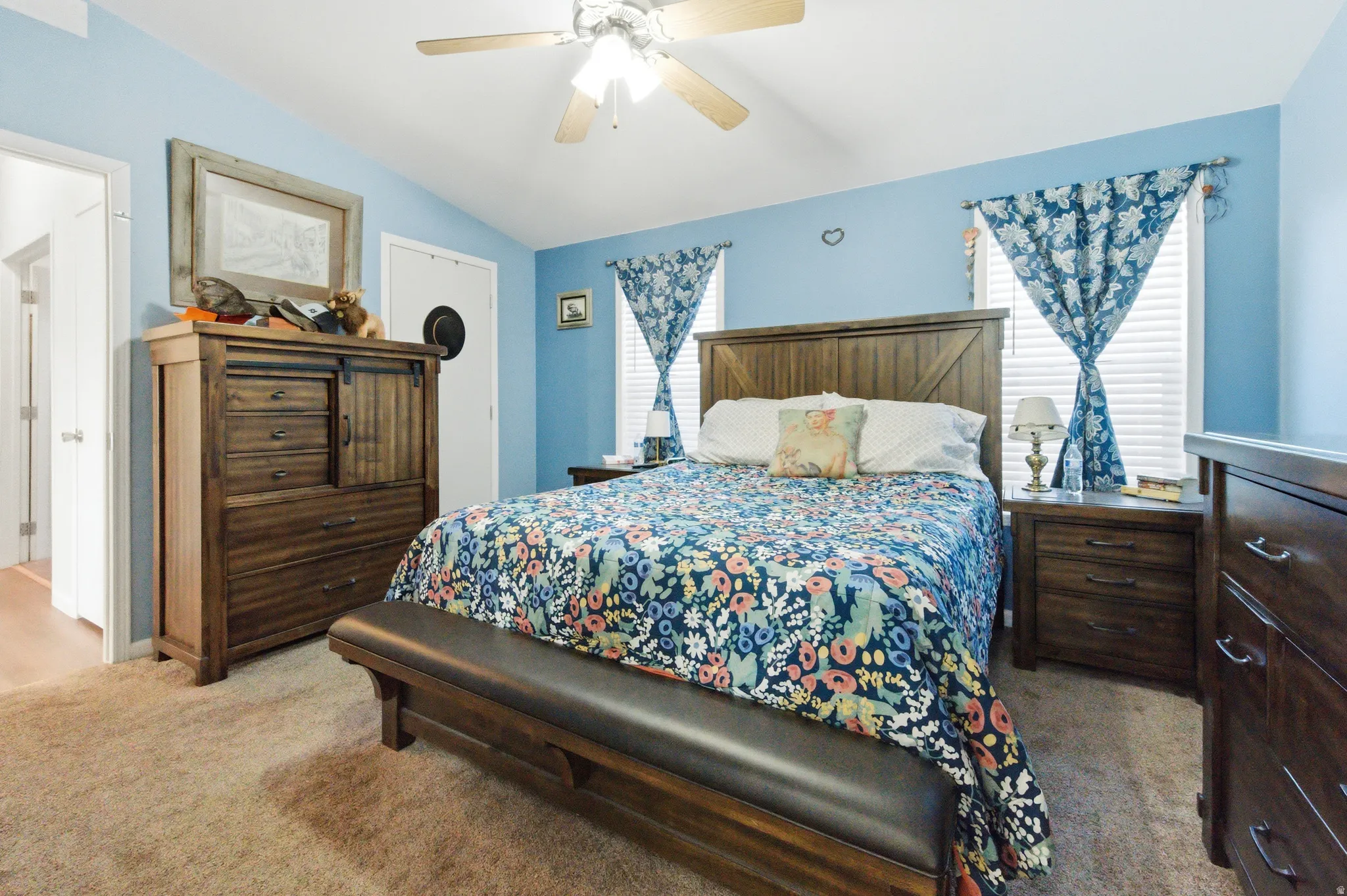 Bedroom with light colored carpet, lofted ceiling, ceiling fan, and a closet