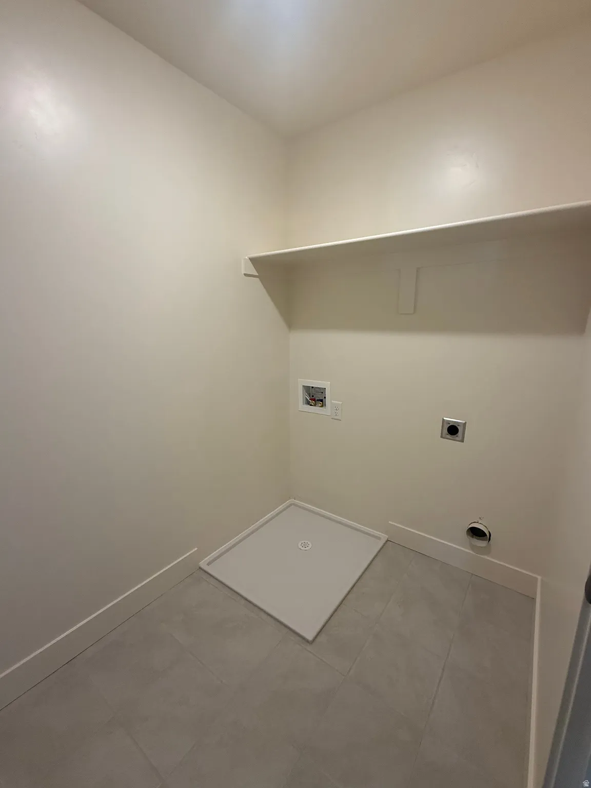 Washroom featuring hookup for a washing machine and electric dryer hookup