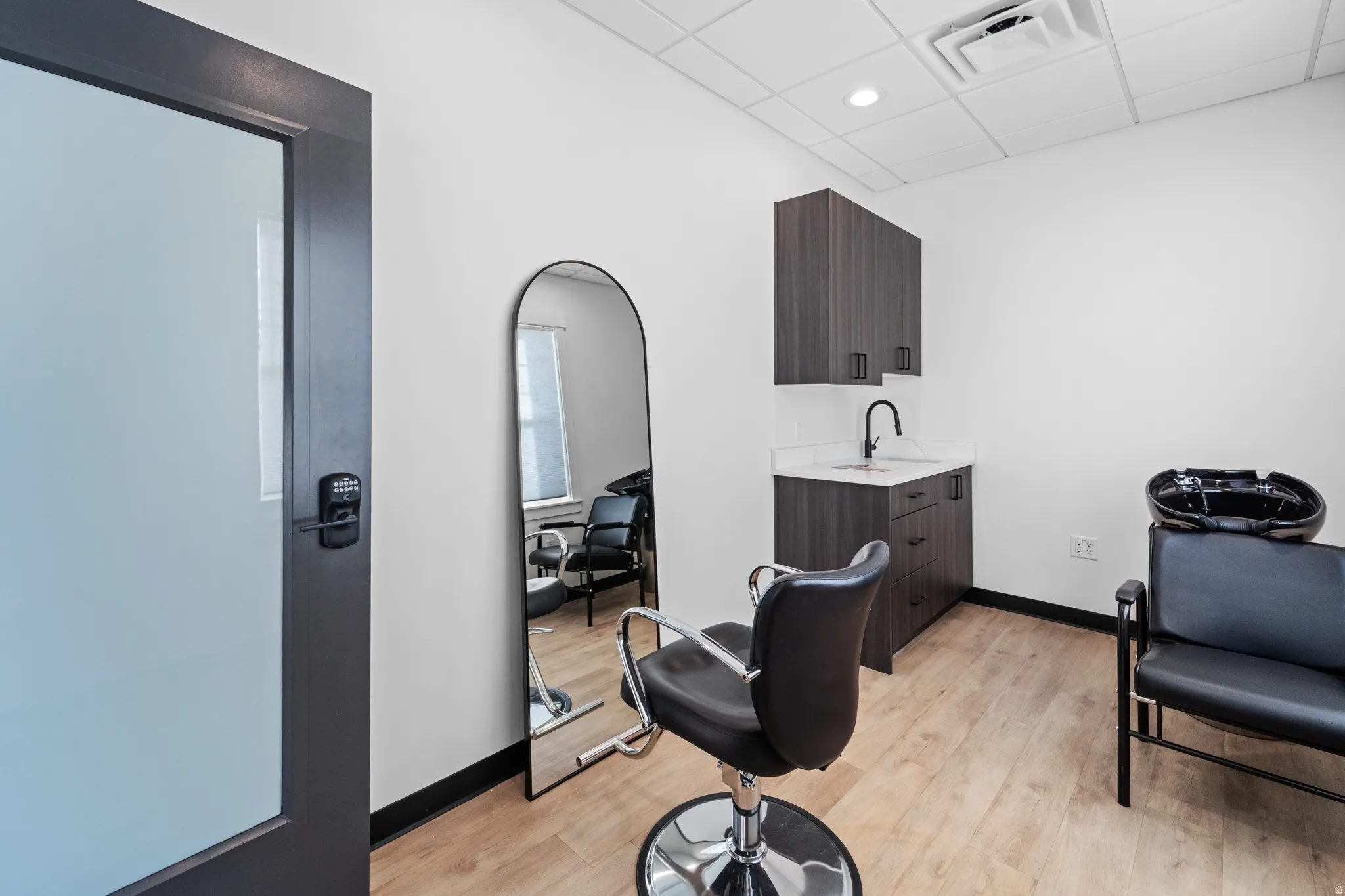 Miscellaneous room with a paneled ceiling and a sink