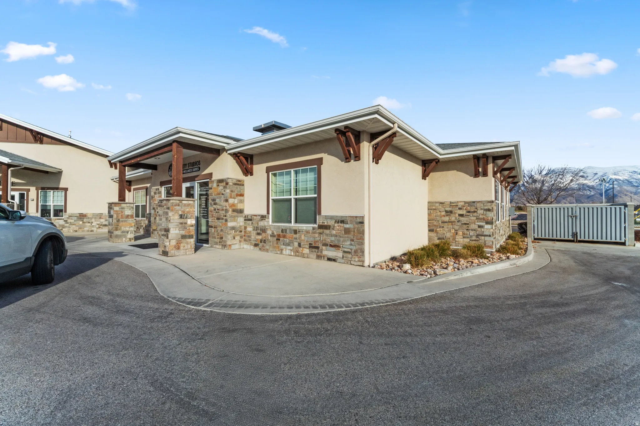 View of front of property with stucco siding and stone siding