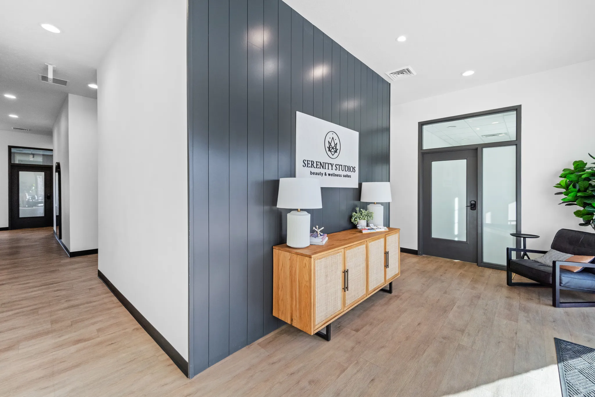 Hallway featuring recessed lighting, light wood-style flooring, and wood walls