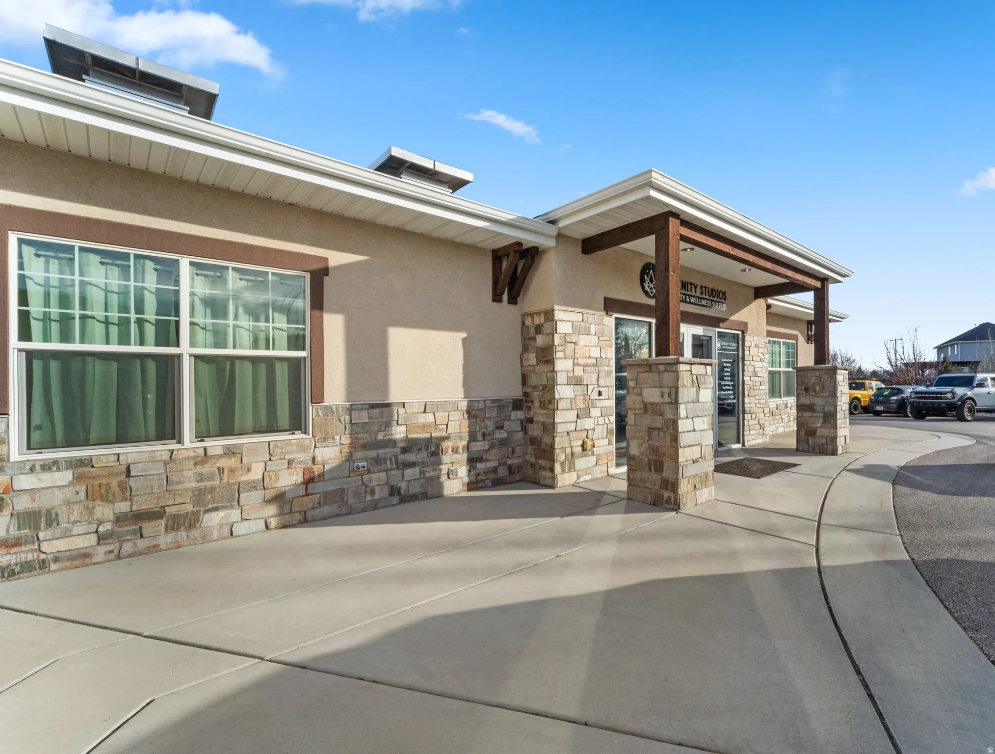 Doorway to property with stone siding and stucco siding