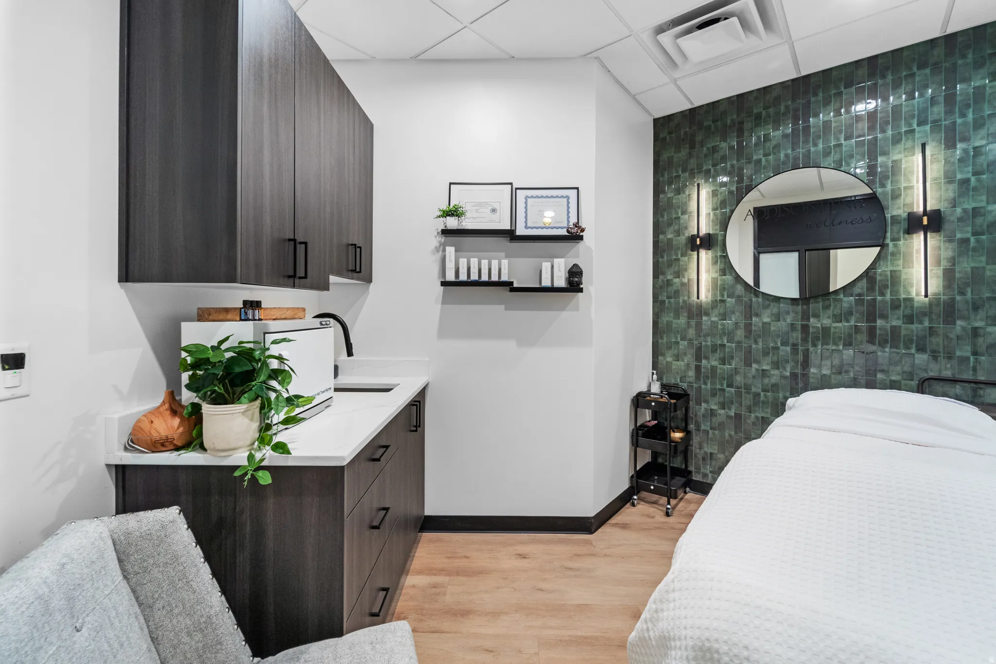 Bedroom with a drop ceiling and light wood-style flooring