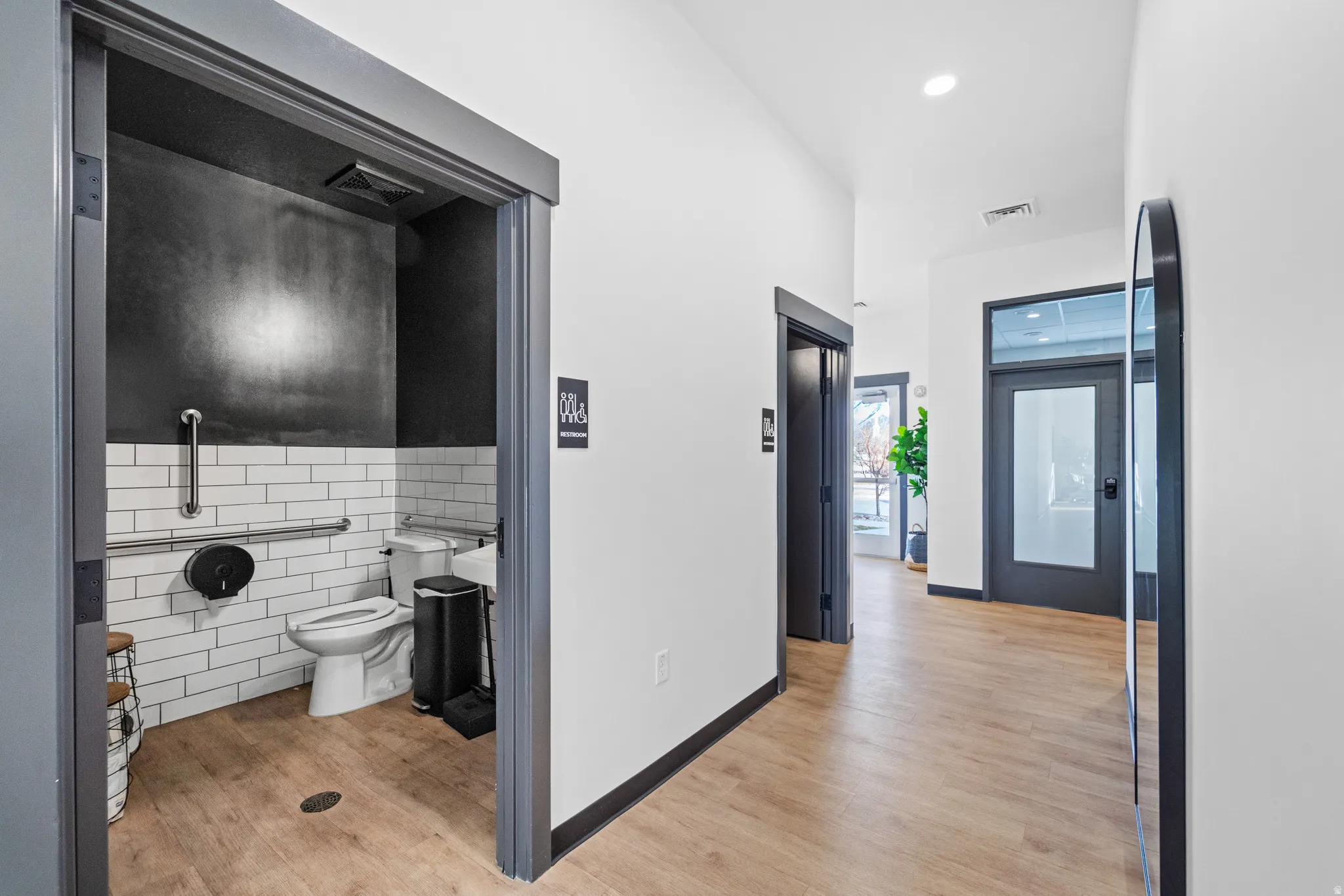 Bathroom with tile walls and light wood finished floors